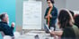 np_Businesswoman explaining business strategy on a board while team looks on_0yqda0_free Cropped