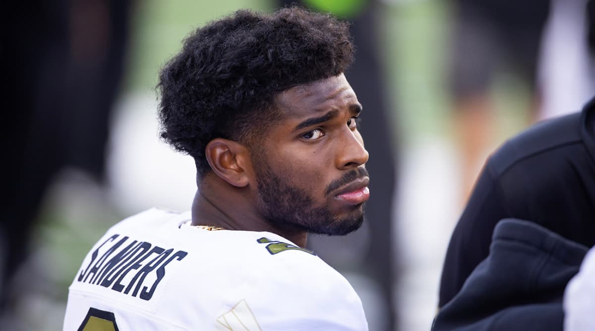 A young american football player showing a concerned face. 